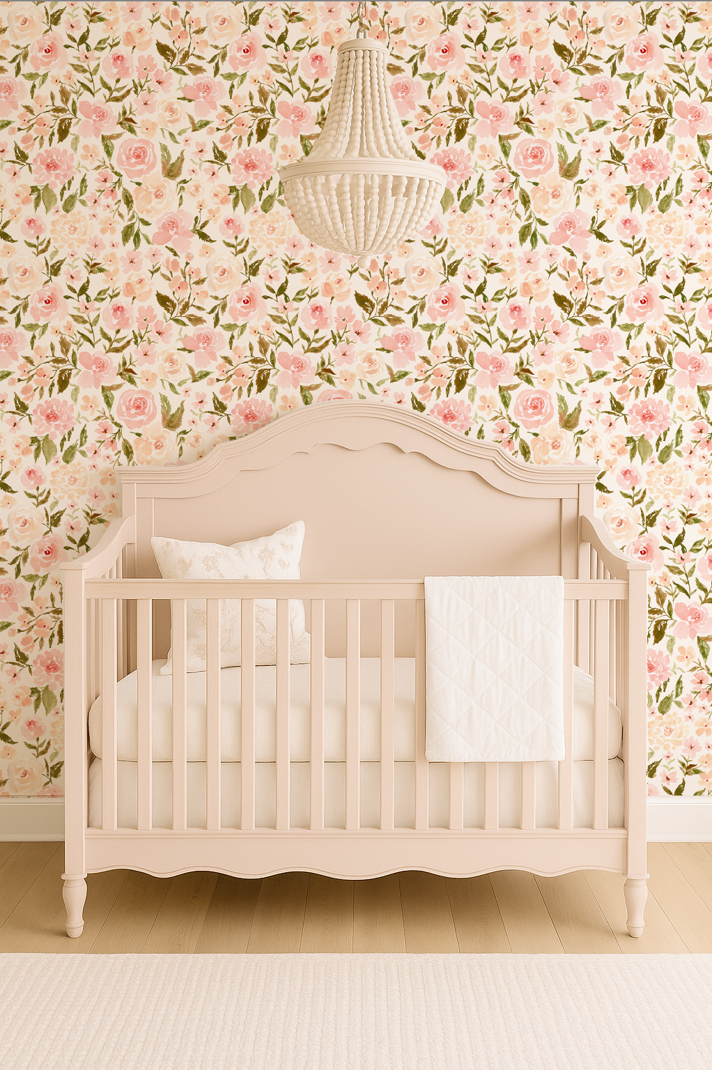 Crib in a room with floral wallpaper and a chandelier.