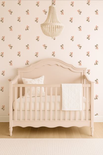 Beige crib with white bedding against a floral wallpaper wall.