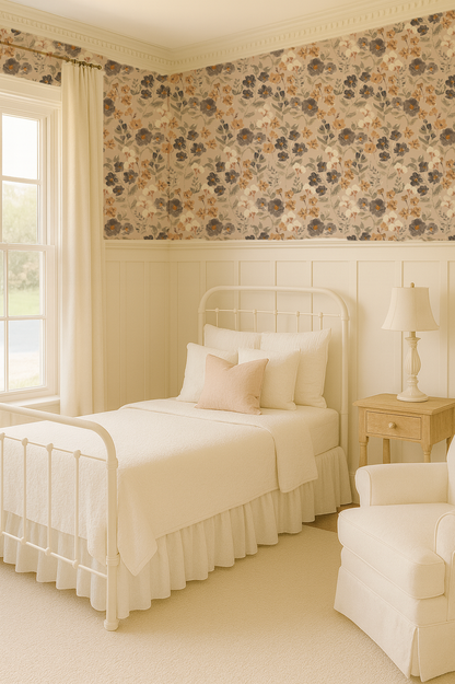 Neatly made bed in a bedroom with floral wallpaper and a lamp on a nightstand.