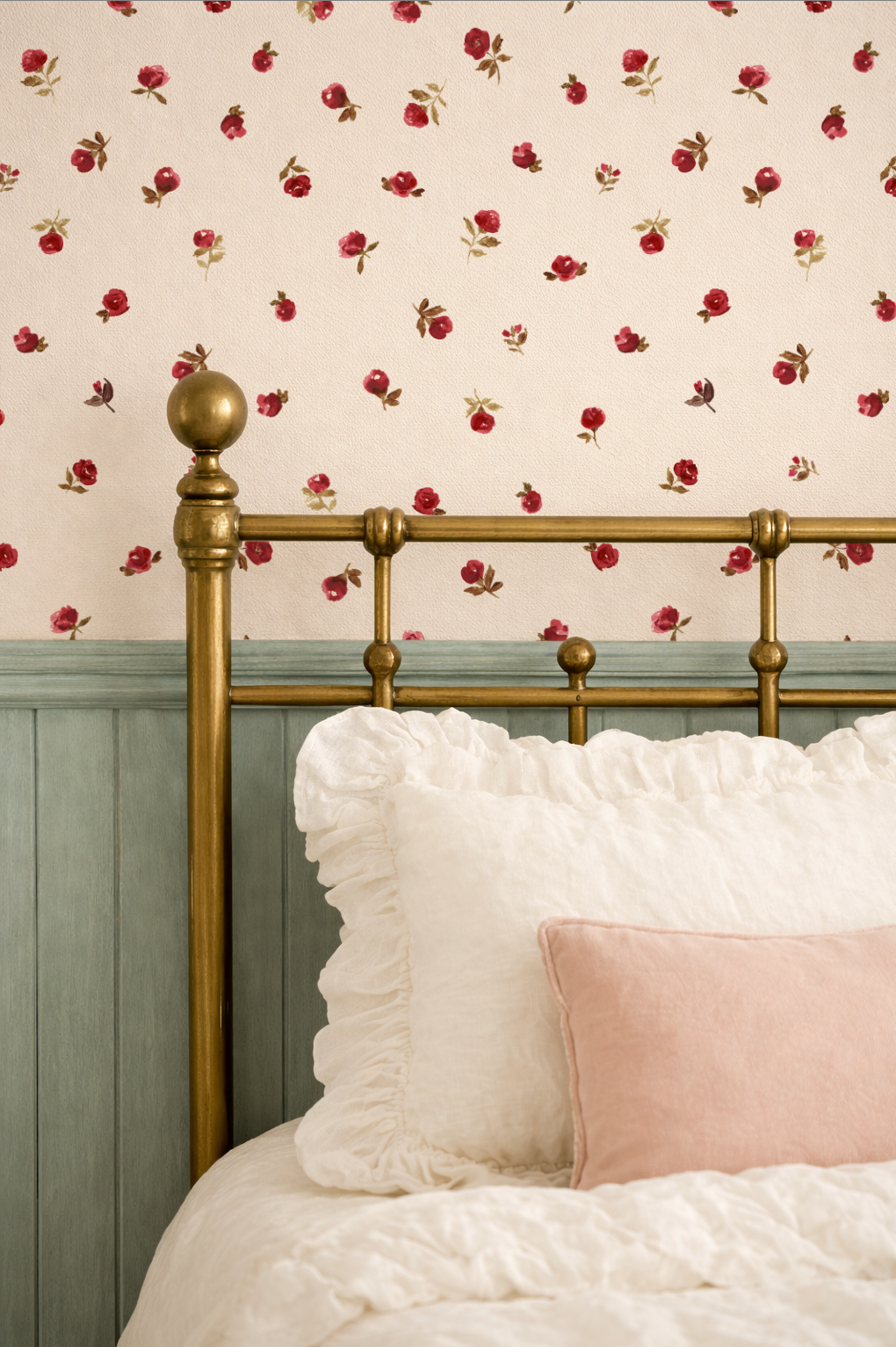 Bed with gold headboard and white bedding against floral wallpaper