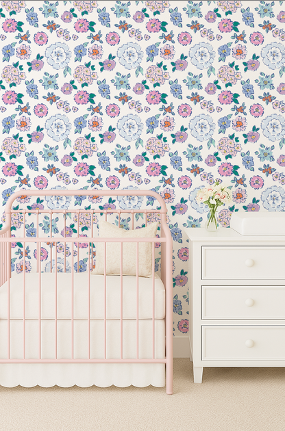 Nursery room with floral wallpaper, pink crib, and white dresser.