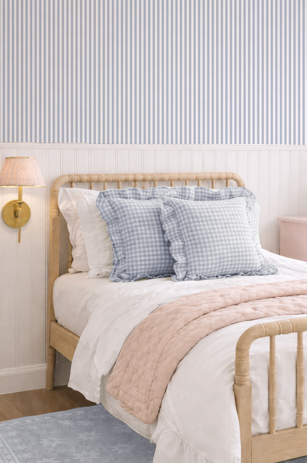 Blue grey stripe wallpaper in cozy bedroom with wooden bed and soft pillows.