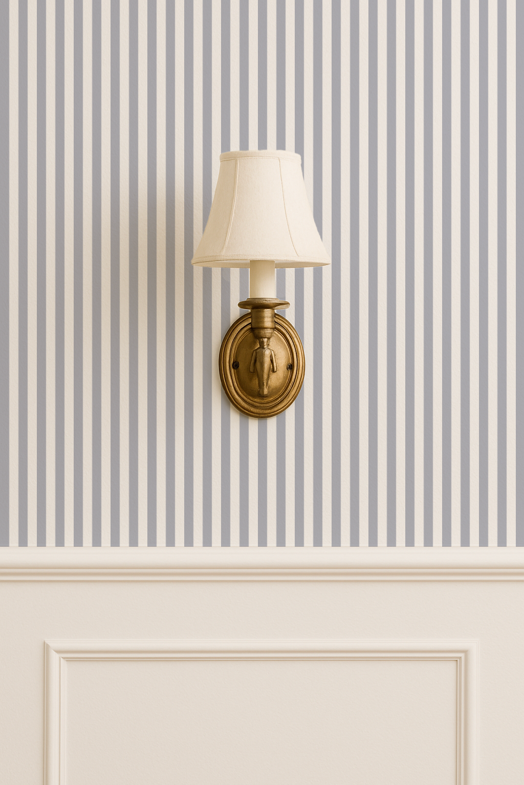 Blue grey striped wallpaper with brass wall sconce in elegant room setting.