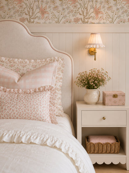 Blush floral wallpaper in cozy bedroom with soft pink bedding and vintage decor.