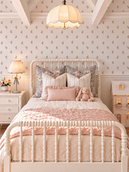 Blush floral wallpaper in cozy bedroom with vintage decor and soft pink accents.