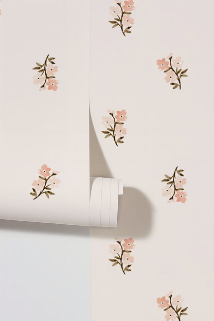 Blush floral wallpaper with small flowers on a pale background.