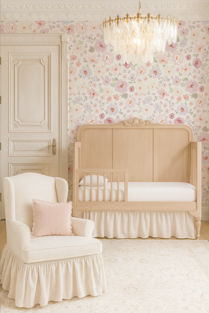 Nursery room with beige crib, white chair, and floral wallpaper. Indy bloom design wallpaper
