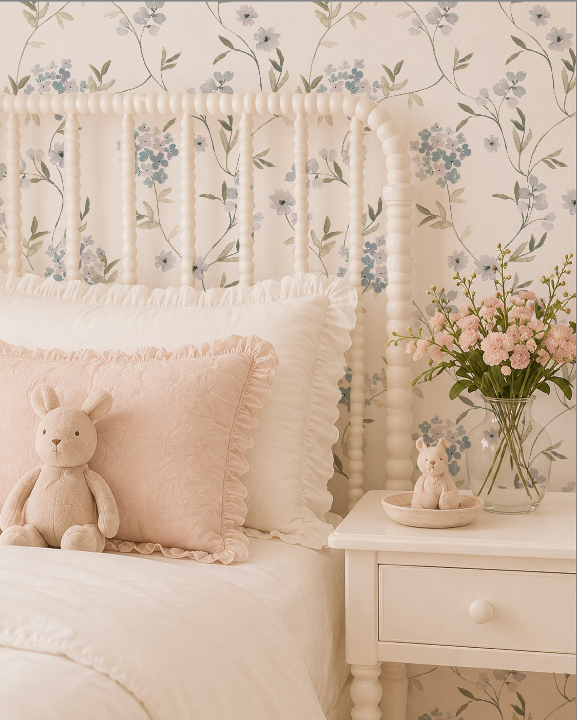 Children's bedroom with floral wallpaper, bed with pillows and teddy bear, and nightstand with flowers.