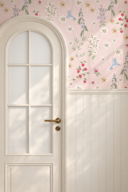 Hummingbird and floral wallpaper on blush backdrop in a cozy room with arched door.
