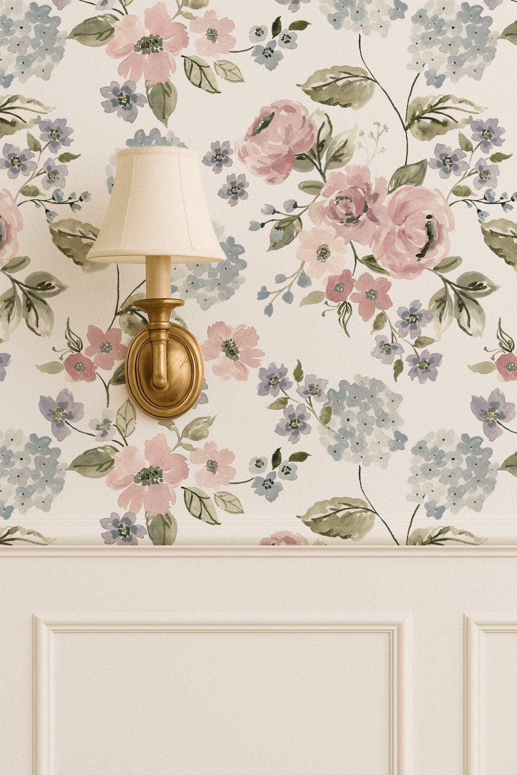 Floral wallpaper with blush pink and blue hydrangeas in a vintage room with wall sconce.