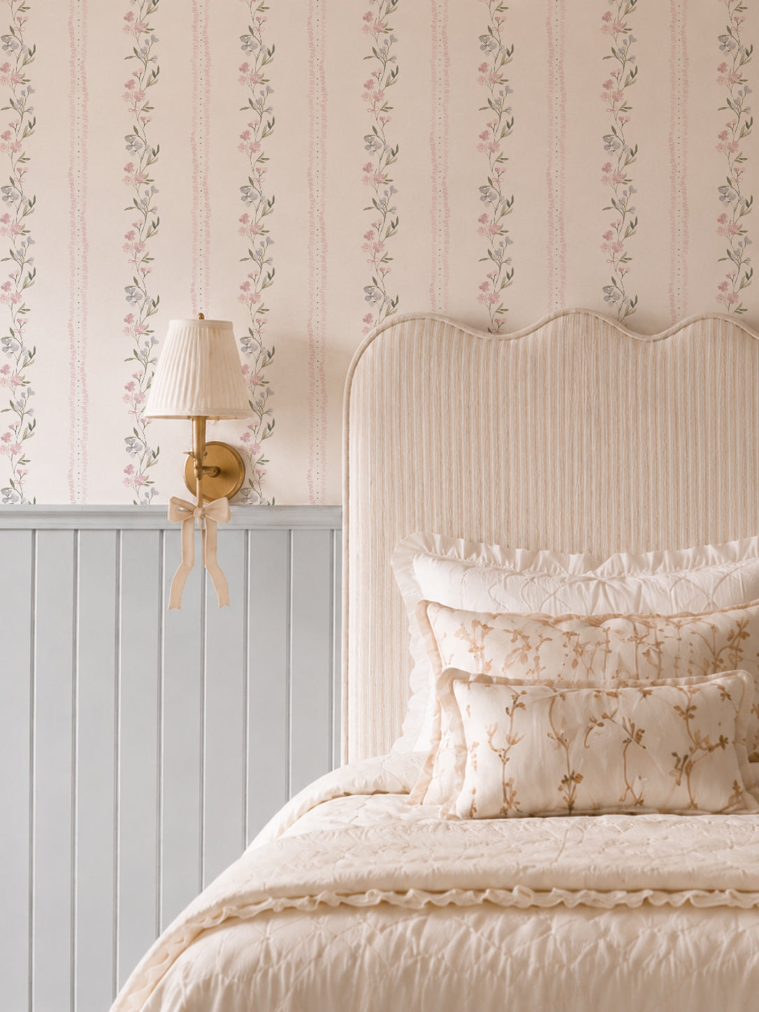 Lacey Lou floral wallpaper with pink and blue flowers in cozy bedroom setting.