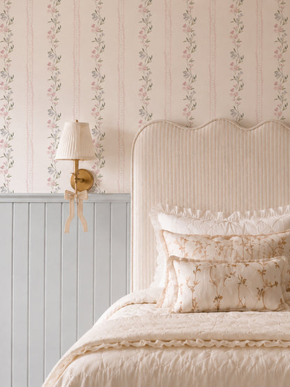 Lacey Lou floral wallpaper with pink and blue flowers in cozy bedroom setting.