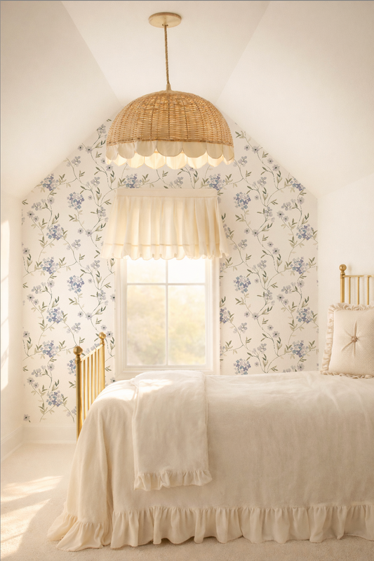 Bedroom with lavender hydrangea floral wallpaper, soft bedding, and wicker pendant light.