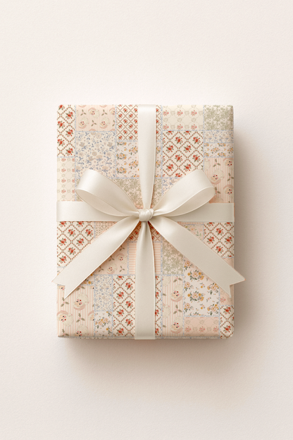 Gift box wrapped in patterned paper with a white ribbon on a light background