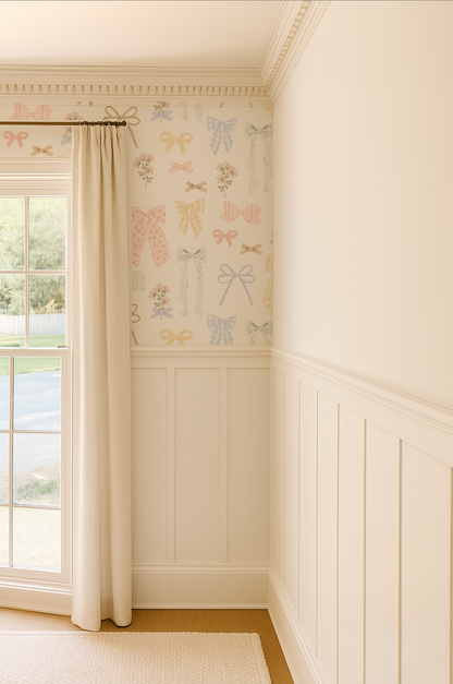 Room interior with decorative wallpaper featuring bows and a window with white curtains.